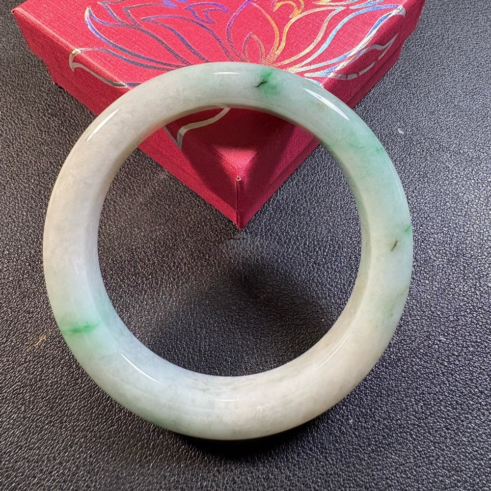 Jadeite jade bangle bracelet. Type A, moss in snow. Green on white base.